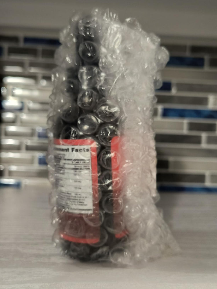 Bottles wrapped in bubble wrap with a label on a tiled floor background cayenne pepper drops from micronutrients