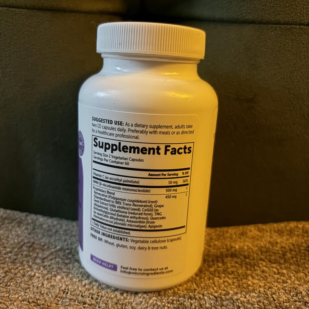 NMN Supplement bottle with label on a brown surface