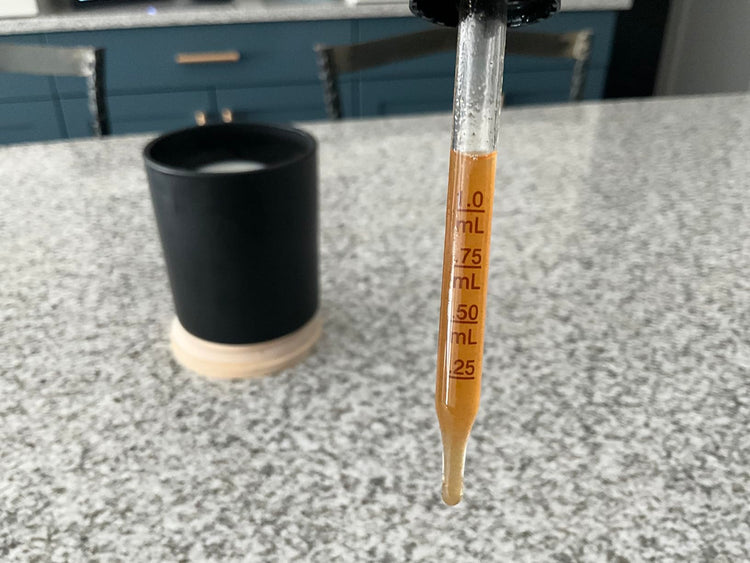 Graduated cylinder with liquid on a kitchen counter