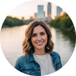 Woman standing by a lake with a city skyline in the background