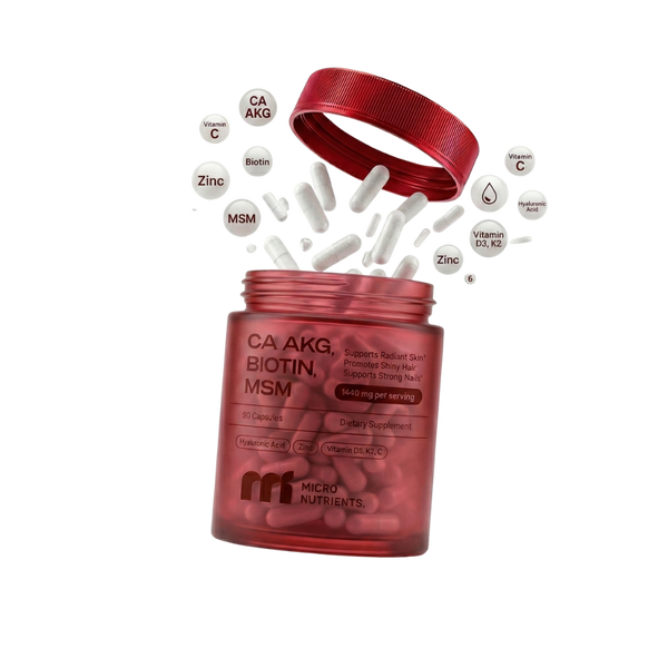 Ca-AKG Beauty supplement bottle with white capsules spilling out on a white background