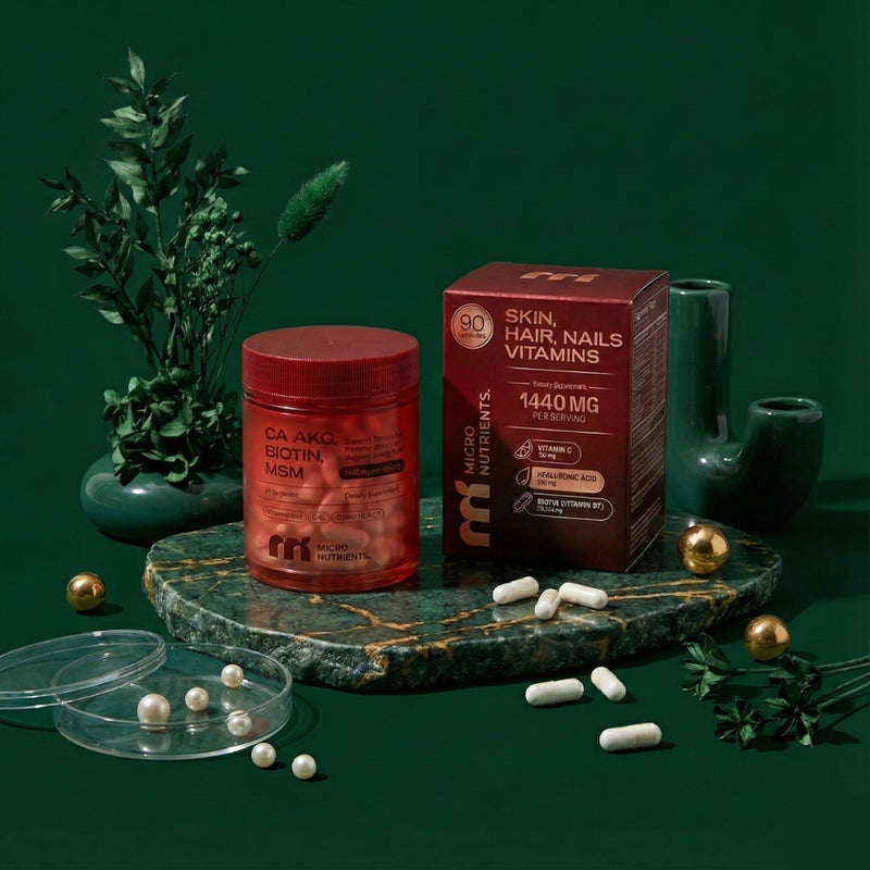 Ca-AKG Supplement and vitamins on a dark green surface with decorative elements.