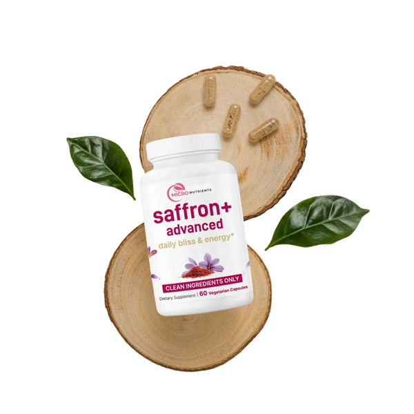 Saffron+ Advanced supplement bottle on a wooden slice with saffron threads and leaves.