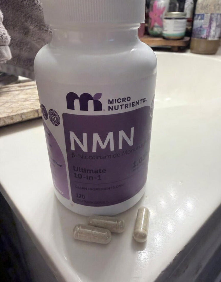 Bottle of Micro Nutrients NMN with capsules on a counter
