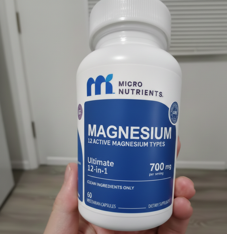 Bottle of Micro Nutrients magnesium supplement held in a hand.