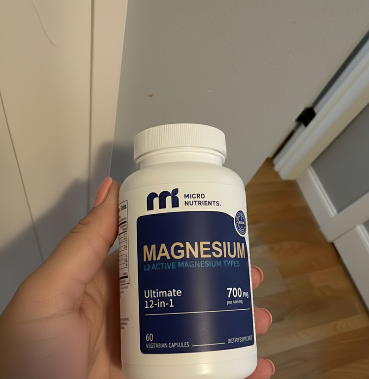 Hand holding a bottle of Micro Nutrients Magnesium supplement.