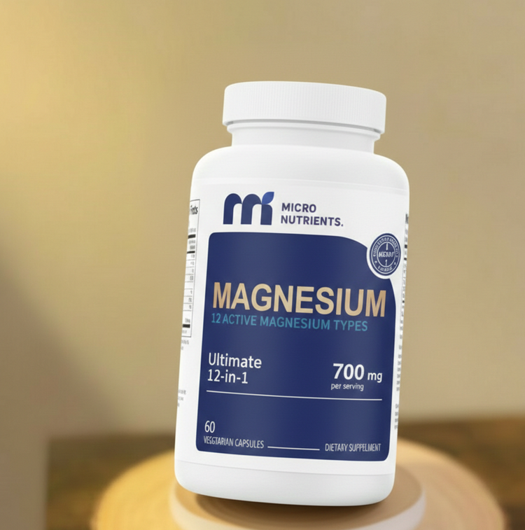 Supplement bottle labeled 'Magnesium' by Micro Nutrients on a wooden surface with a blurred background.