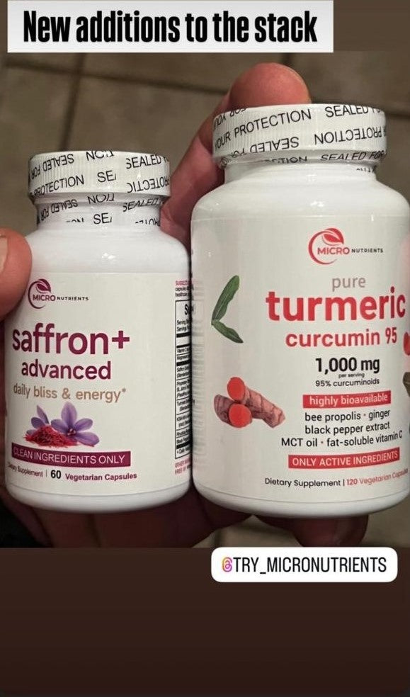 Two bottles of Micronutrients supplements, one labeled 'saffron+' and the other 'pure turmeric curcumin', held by a hand.