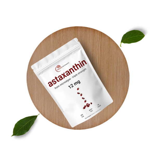 Package of astaxanthin supplement on a wooden board with leaves
