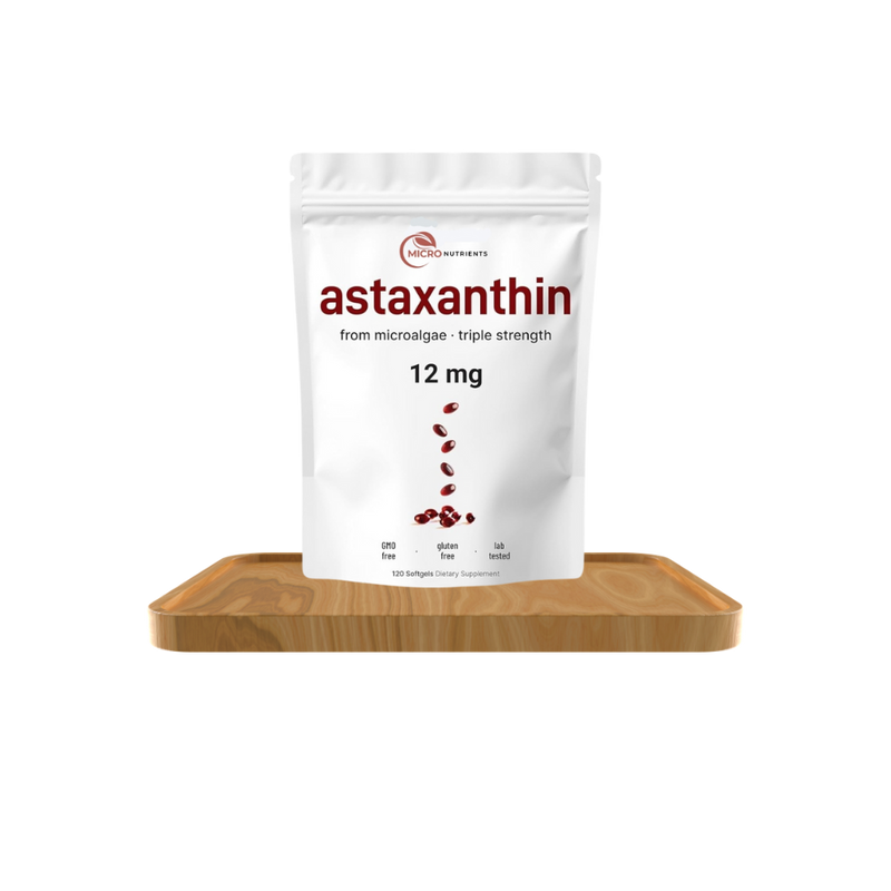 Package of astaxanthin supplement on a wooden board with a white background