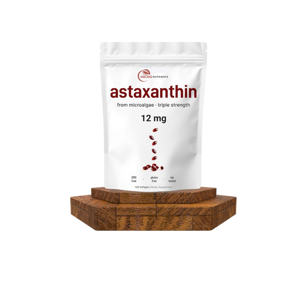 White packaging of astaxanthin on a wooden stand with a white background