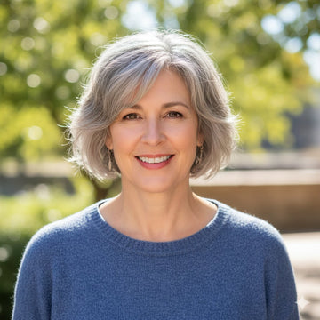 Woman with gray hair wearing a blue sweater outdoors