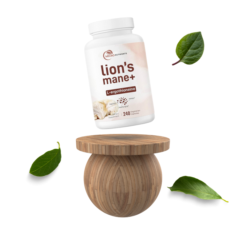 Supplement bottle labeled 'Lion's Mane+' on a wooden stool with leaves around on a white background