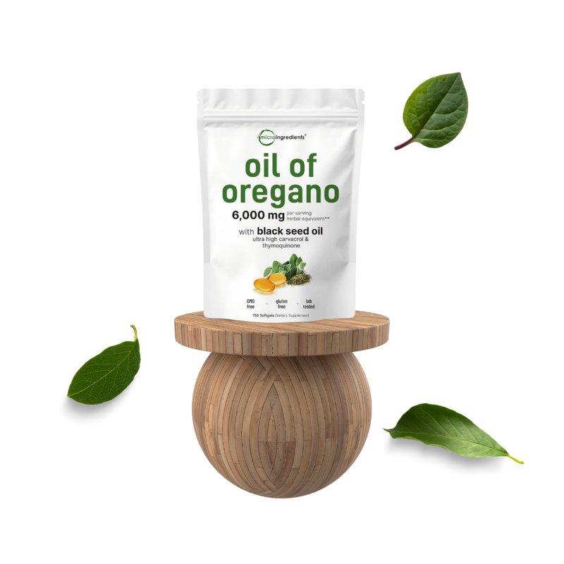 Bag of 'oil of oregano' on a wooden stand with green leaves around on a white background