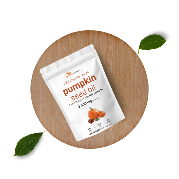 Pumpkin seed oil package on a wooden board with leaves