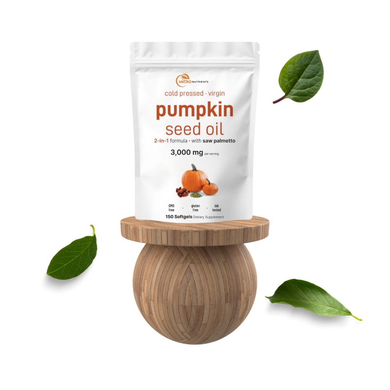 Pumpkin seed oil package on a wooden stand with leaves on a white background