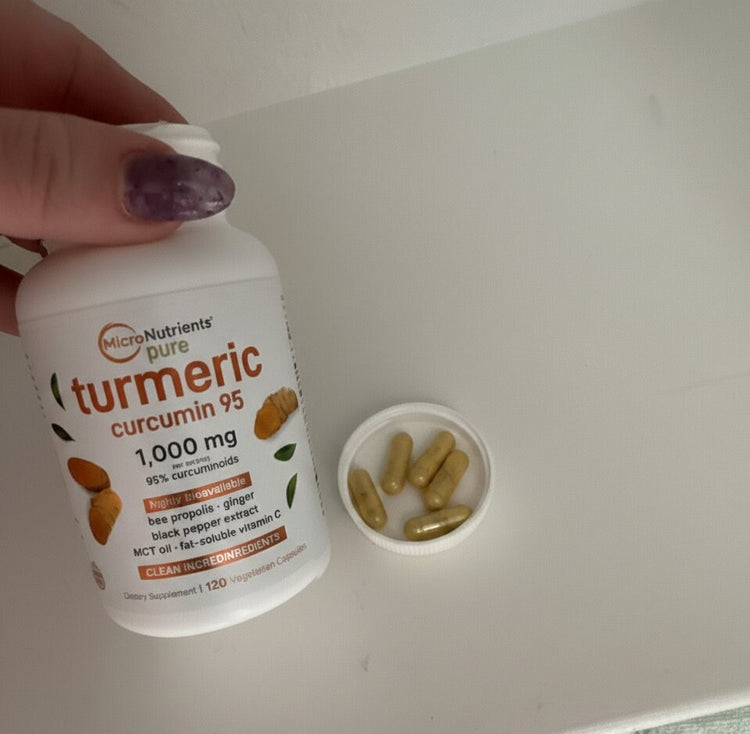 Bottle of MicroNutrients pure turmeric curcumin 95 with capsules on a white surface