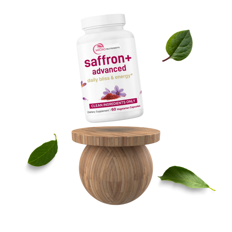 Supplement bottle labeled 'saffron+ advanced' on a wooden stand with leaves around on a white background