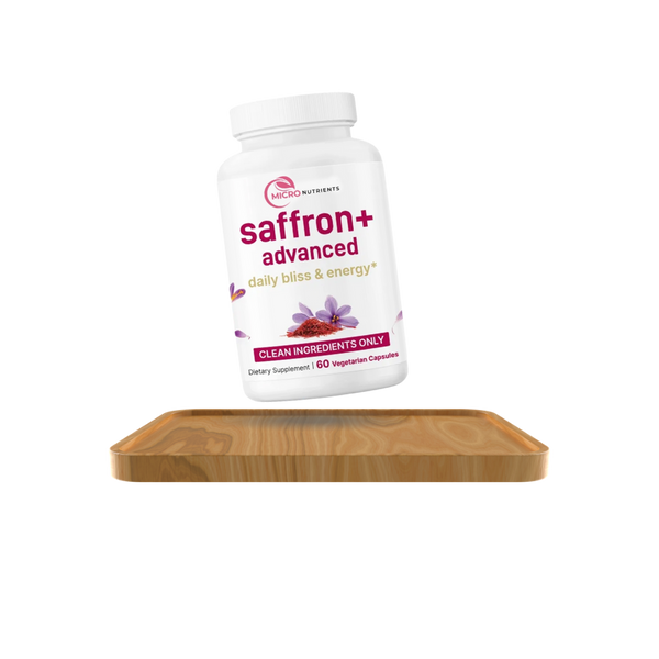 Supplement bottle labeled 'saffron+ advanced' on a wooden tray with a white background