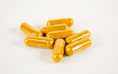 Turmeric capsules on a white background