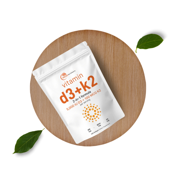 Vitamin D3 + K2 package on a wooden board with leaves